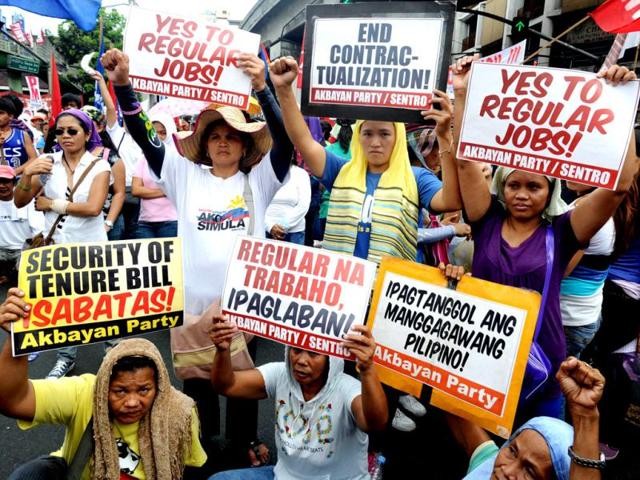 More than a thousand labour union members gather and show placards during a march towards the presidential palace in Manila, as part of the May Day protests, demanding higher wages and policies that would make it harder to fire workers. (AFP Photo)