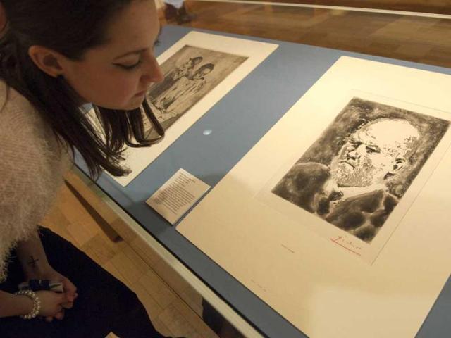 A woman looks at a sugar aquatint entitled "Portrait of Vollard,I (1937) " by spanish artist Pablo Picasso at the British Museum in central London. A set of 100 prints and etchings by the Spanish painter went on display in London. AFP Photo / Miguel Medina