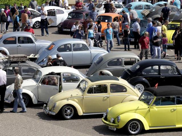 People look at vintage Volkswagen cars during the 29th annual "MaiKaeferTreffen" (May Beetle meeting) meeting in Hanover. (Reuters/Tobias Schwarz)