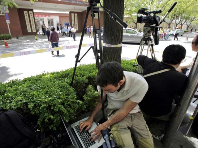 Members of the media wait outside Chaoyang Hospital, where blind activist Chen Guangcheng was reported to be staying at, in Beijing. Reuters/Carlos Barria