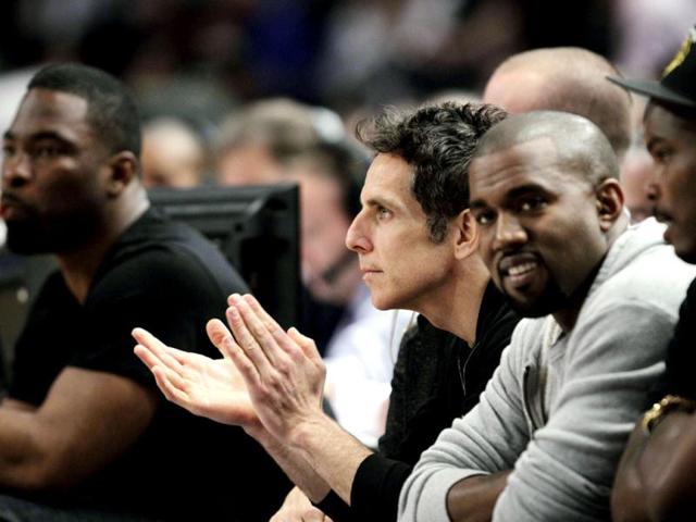 Actor Ben Stiller (2nd from L) applauds alongside New York Giants' Justin Tuck (L) and rapper Kanye West (2nd from R) as they watch Game 3 of an NBA basketball first-round playoff series between the Miami Heat and New York Knicks at Madison Square Garden. AP Photo/Kathy Willens