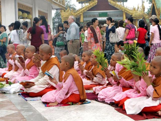 Myanmar Buddhist nuns pray at Myanmar's fame Shwedagon Pagoda on the full-moon day of Kasone, the second month of Myanmar Calendar. in Yangon, Myanmar. (AP Photo/Khin Maung Win)