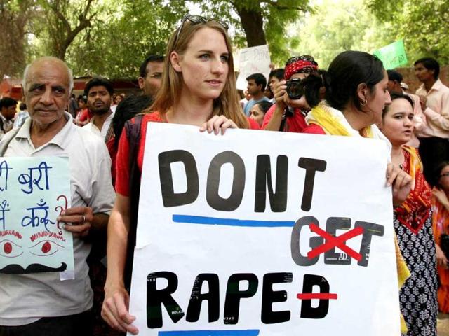 Protesters hold placards during a protest against growing cases of sexual abuse in New Delhi. HT Photo