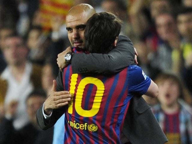 FC Barcelon's coach Pep Guardiola, left, embraces Lionel Messi, from Argentina, after scores during a Spanish La Liga soccer match at the Camp Nou stadium in Barcelona, Spain. (AP Photo/Manu Fernandez)