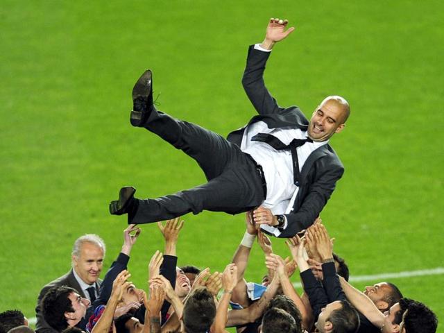 FC Barcelon's coach Pep Guardiola is thrown in the air after the match FC Barcelona and Espanyol during a Spanish La Liga soccer match at the Camp Nou stadium in Barcelona, Spain. (AP Photo/Manu Fernandez)