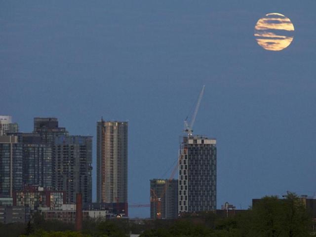 The Supermoon rises over apartment buildings in Toronto. Reuters/Mark Blinch