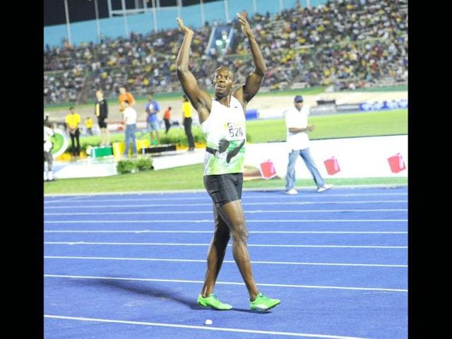Jamaica's Usain Bolt acknowleges the large crowd after running a world leading 9.82 seconds to win the men's 100 metre at the Jamaica International Invitational at the National Stadium in Kingston Jamaica. AFP/Ricardo Makyn