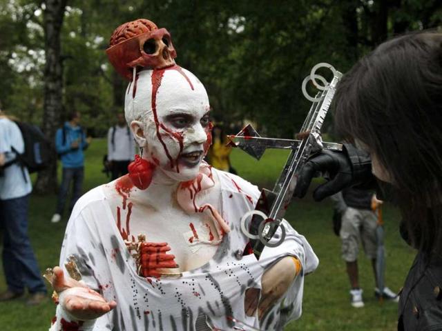 A participant dressed and made up as a zombie prepares for a traditional Zombie Walk across the Charles Bridge in Prague, Czech Republic. (AP Photo/Petr David Josek)