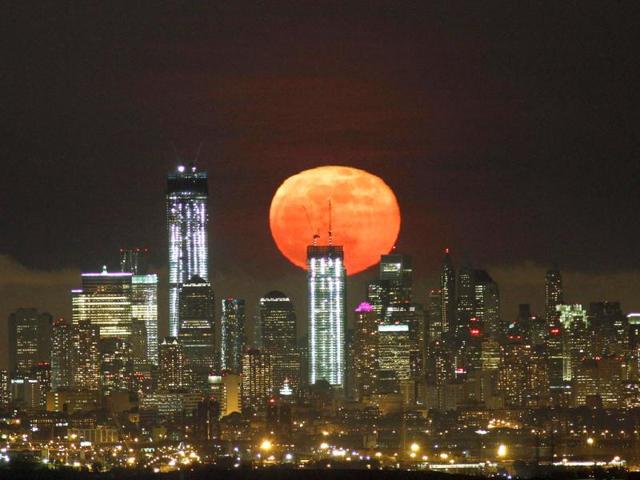 A full moon as seen from West Orange, New Jersey, rises over the skyline of Lower Manhattan and One World Trade Center (L) in New York. Reuters/Gary Hershorn