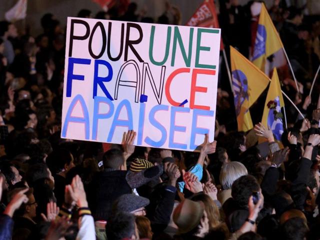 Supporters of France's newly-elected President Francois Hollande celebrate during a victory rally at Place de la Bastille in Paris. France voted in elections on Sunday and Francois Hollande becomes the nation's first Socialist president in 17 years. The slogan reads " "For an appeased France". Reuters/Yves Herman