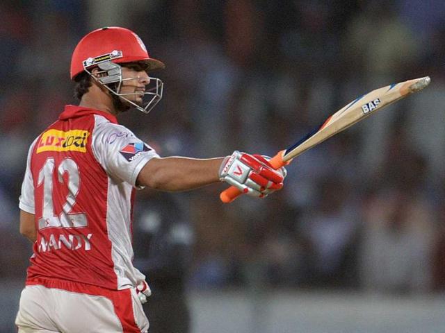 Kings XI Punjab batsman Mandeep Singh raises his bat after scoring a half century during the IPL Twenty20 cricket match between Deccan Chargers and Kings XI Punjab at the Rajiv Gandhi International Stadium in Hyderabad. AFP Photo/Noah Seelam