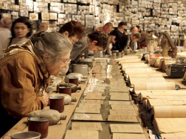 Visitors examine war documents looking for information about their relatives in a World War II museum on Victory Day in Kiev, Ukraine. AP/Efrem Lukatsky