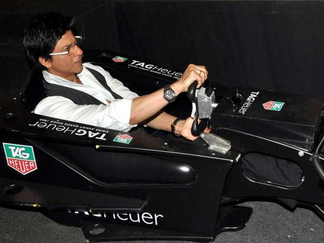 Bollywood actor Shah Rukh Khan, brand ambassador for TAG Heuer participtes in a racing game during the launch of the newest Boutique in Mumbai. (AFP)