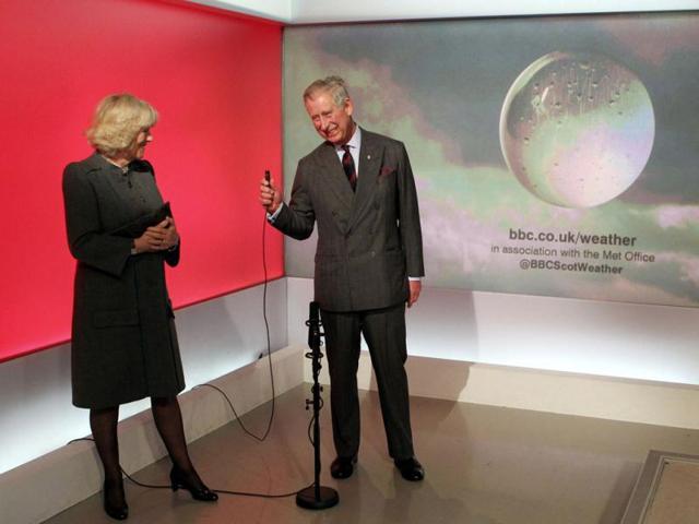 Britain's Prince Charles is watched by his wife Camilla, Duchess of Cornwall, as he presents a special weather forecast during a visit to BBC Scotland's headquarters in Glasgow, Scotland. Reuters/ Andrew Milligan/Pool