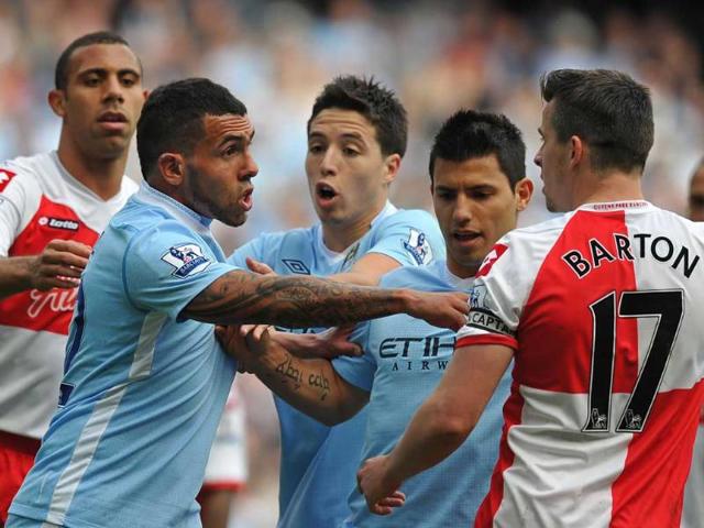Queens Park Rangers' English midfielder Joey Barton (R) clashes with Manchester City's Argentinian striker Carlos Tevez (2nd L) during the English Premier League football match at the Etihad stadium, north-west England. AFP/Paul Ellis Queens Park Rangers' English midfielder Joey Barton (R) clashes with Manchester City's Argentinian striker Carlos Tevez (2nd L) during the English Premier League football match at the Etihad stadium, north-west England. AFP/Paul Ellis