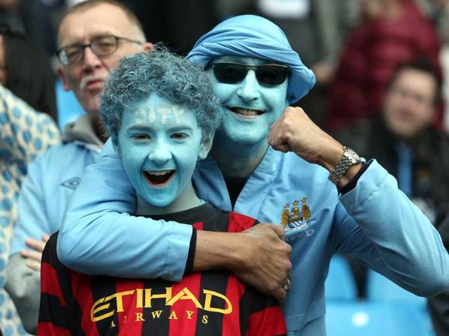 Manchester City fans smile in the stands during the English Premier League soccer match against Queens Park Rangers at the Etihad Stadium, Manchester, England. AP/Jon Super Manchester City fans smile in the stands during the English Premier League soccer match against Queens Park Rangers at the Etihad Stadium, Manchester, England. AP/Jon Super
