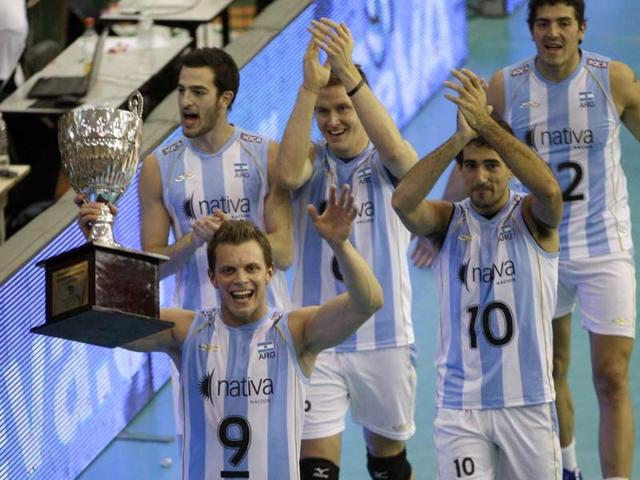 Argentina's Rodrigo Quiroga lifts the trophy after his team beat Venezuela during an Olympic volleyball qualifying match in Buenos Aires, Argentina. AP/Eduardo Di Baia