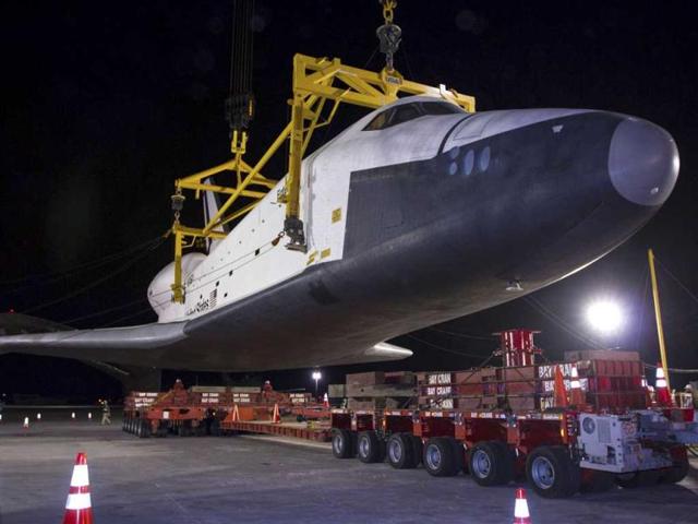 The space shuttle Enterprise is lowered onto a transport vehicle after being demated from the NASA 747 Shuttle Carrier Aircraft (SCA) at John F. Kennedy (JFK) International Airport in Jamica, New York. Reuters/NASA