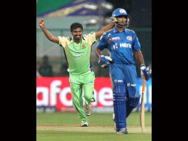 Royal Challengers Bangalore M Murlidharan celebrates the wicket of Mumbai Indian Dinesh Karthick during IPL 5 match in Bangalore. PTI/Shailendra Bhojak