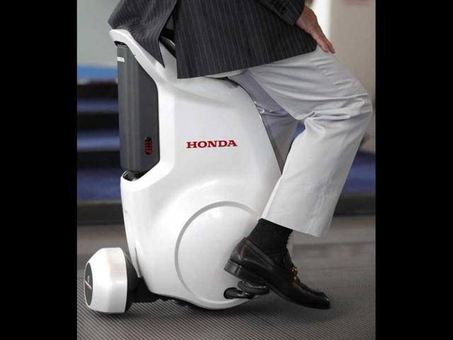 Mamoru Mori, executive director of National Museum of Emerging Science and Innovation (Miraikan) and former astronaut, rides Honda Motor Co's new UNI-CUB personal mobility device at the museum in Tokyo. Reuters/Yuriko Nakao