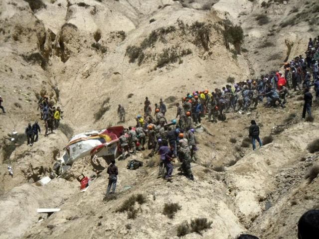 Onlookers and rescuers are seen near the wreckage of an Agni Air Dornier Do 228 aircraft at the crash site in Jomsom, some 300 kms west of Kathmandu. AFP/Santosh Sherchan