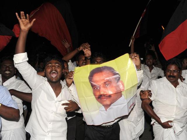 Supporters of former telecom minister A Raja shout slogans and wave poster at his residence. Raja was granted bail by a Delhi court in the 2G spectrum case. AFP/Sajjad Hussain