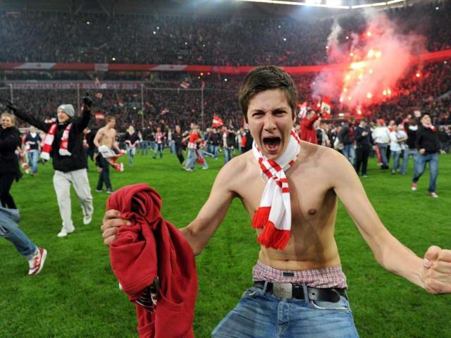 Duesseldorf fans celebrate after the Relegation match for Germany´s first division Bundesliga between Fortuna Duesseldorf and Hertha BSC Berlin in the German city of Duesseldorf. AFP/Patrik Stollarz