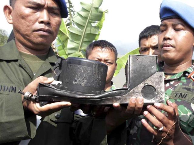Indonesian soldiers hold the burnt cockpit voice recorder of a Sukhoi Superjet-100 that crashed into a mountain in West Java last week, during a press conference in Cijeruk, West Java, Indonesia. AP Photo