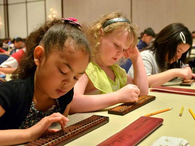 Children from a US school in Japan compete during the annual abacus contest in Tokyo. AFP/Yoshikazu Tsuno