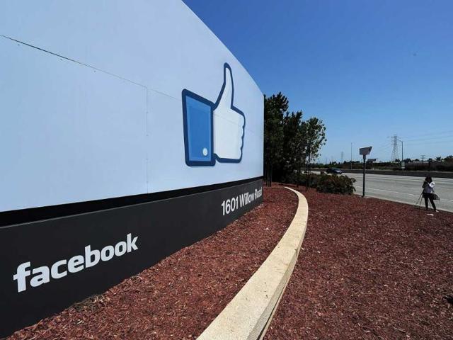 A-woman-shoots-a-video-of-the-sign-at-the-entrance-to-the-Facebook-main-campus-AFP-Robyn-Beck