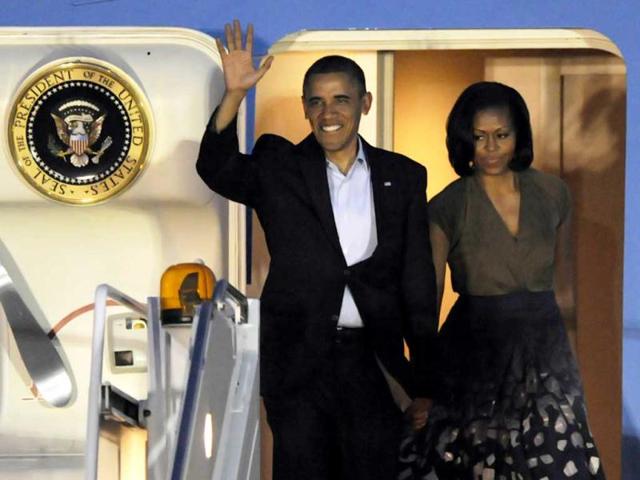 US President Barack Obama and first lady Michelle Obama arrive at Chicago O'Hare International Airport to attend the Nato Summit. AP Photo/Paul Beaty