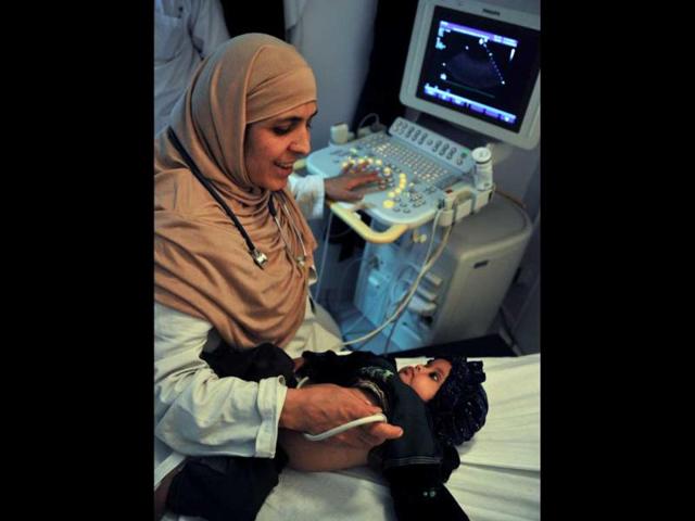 Afghan cardiologist Rahima Stanikzair monitors an infant's heart at the French Medical Institute for Children in Kabul. When the Taliban ruled Afghanistan during 1996-2001, Rahima continued working, as male medical personel were banned from examining women. AFP/Bay Ismoyo