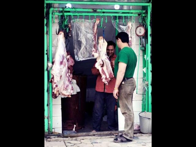 An Afghan meat vendor serves a customer at his shop in Kabul. Poverty and an ongoing insurgency by the ousted Taliban still pose a threat to the stability of the country. AFP/Bay Ismoyo