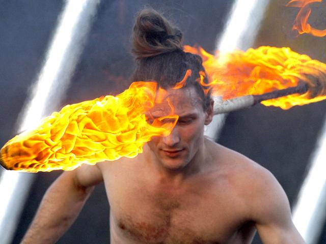 An artist turns fire around his neck as he takes part in a two-day fire festival in Minsk, Belarus. (AP Photo/Sergei Grits)