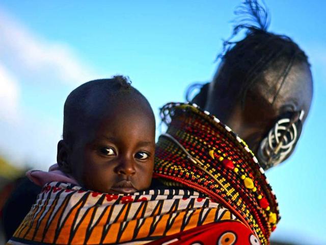 A woman from the Turkana tribe carries a baby on her back at the Lake Turkana Festival in Loiyangalani, near Lake Turkarna in Northern Kenya. The festival is an annual cultural festival designed to promote tourism in the area and to forge better relationships between the seven different tribes in the area. (AFP Photo)