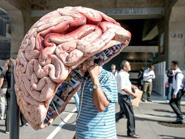 A-man-uses-a-public-phone-booth-decorated-as-a-brain-in-Sao-Paulo-Brazil-AFP-Yasuyoshi-Chiba A-man-uses-a-public-phone-booth-decorated-as-a-brain-in-Sao-Paulo-Brazil-AFP-Yasuyoshi-Chiba