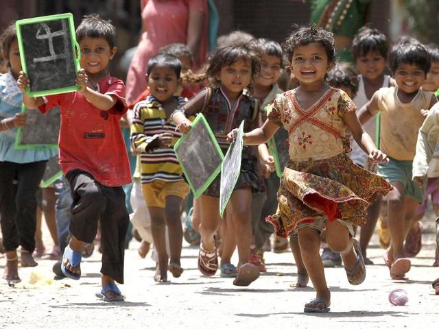 Children are seen running outside a creche in Daya Basti. HT/Raj K Raj