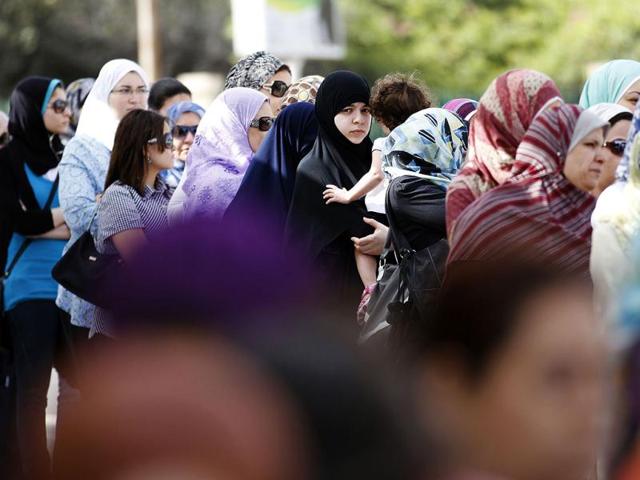 Egyptian women line up outside a polling station to cast their votes during the first day of the presidential elections in Alexandria, Egypt. AP/Khalil Hamra