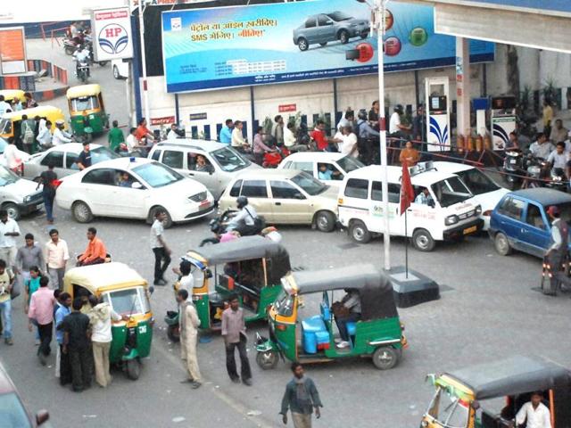 People line up to fill their vehicles at an oil pump after the announcement of hike in petrol prices, in Ghaziabad. PTI photo