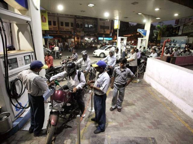 People line up to fill their vehicles at an oil pump in Lucknow after the announcement of hike in petrol prices. PTI/Nand Kumar