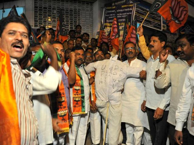 BJP protesters shout slogans as they burn the effigy of the UPA government against the petrol price hike, in Hyderabad. AFP/Noah Seelam