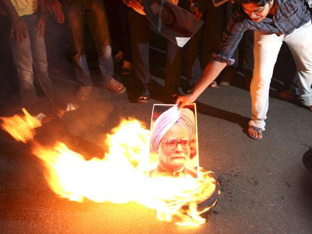 A protester burns a portrait of Prime Minister Manmohan Singh during a protest in Odisha against the steep rise in petrol prices. State oil companies raise the price of petrol for the first time in more than six months in a gesture of fiscal discipline that economists said is unlikely to give a significant lift to the embattled rupee. Reuters photo