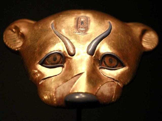 A golden leopard head statue is displayed during a preview of a King Tut exhibit. AP/Elaine Thompson