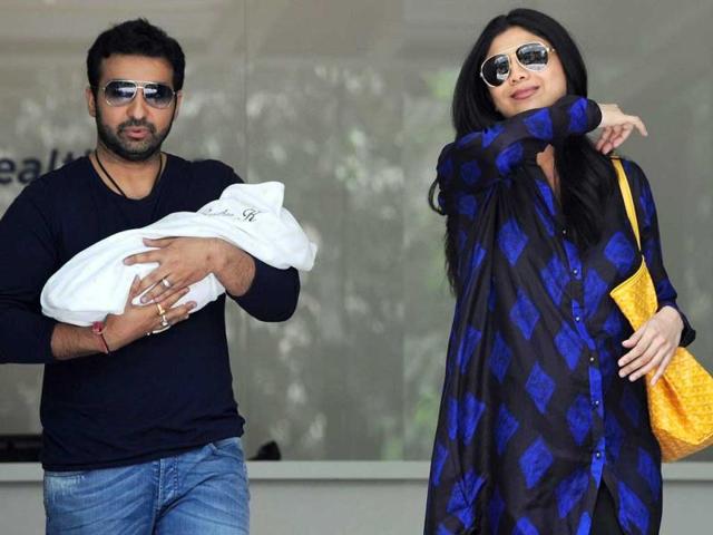 Shilpa Shetty gestures as she and her husband Raj Kundra hold their newborn son.