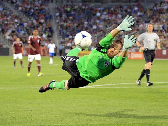 Goalkeeper Matt Pickens #18 of the Colorado Rapids dives to make a save against the Montreal Impact at Dick's Sporting Goods Park in Commerce City, Colorado. The Rapids defeated the Impact 3-2. AFP/Doug Pensinger