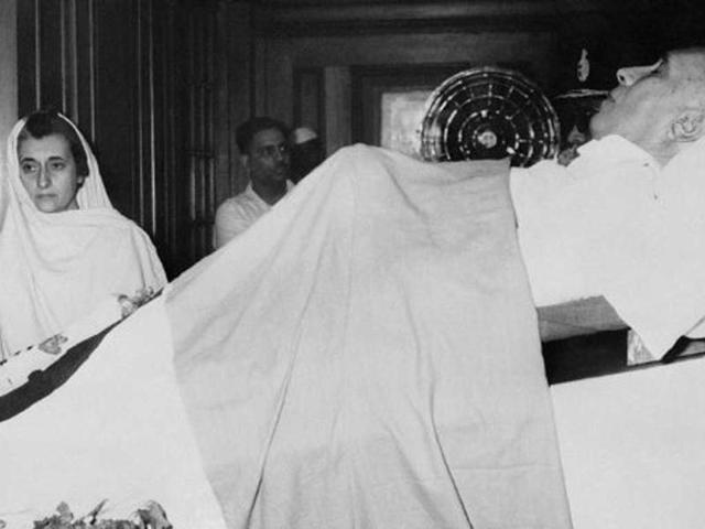 In this file photo, Indira Gandhi pays respect at the body of her father Nehru, India's first Prime Minister, who died at his home after a sudden heart attack, aged 74, 28 May 1964. (AFP Photo)