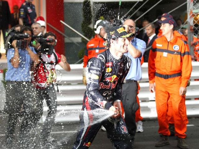 Red Bull driver Mark Webber of Australia celebrates with champagne after winning the Formula One Grand Prix, at the Monaco racetrack, in Monaco. (AP Photo/Luca Bruno)