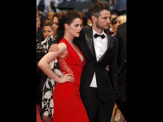 Kristen (pictured here with British actor Tom Sturridge) was wearing a red Reem Acra dress.