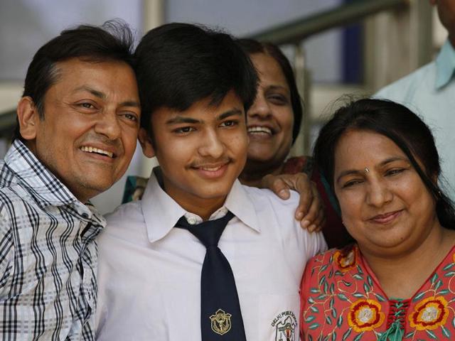 Science 12th class Topper Shitij Jain (98%) along with his family celebrates his success in CBSE class XII examinations results in New Delhi. (HT Photo/Raj K Raj)