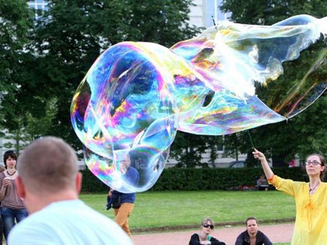 People participate soap bubble gathering in Vilnius during the "Burbuliatorius," which takes place every second Monday in summer time in more than 15 world cities. AFP/Petras Malukas